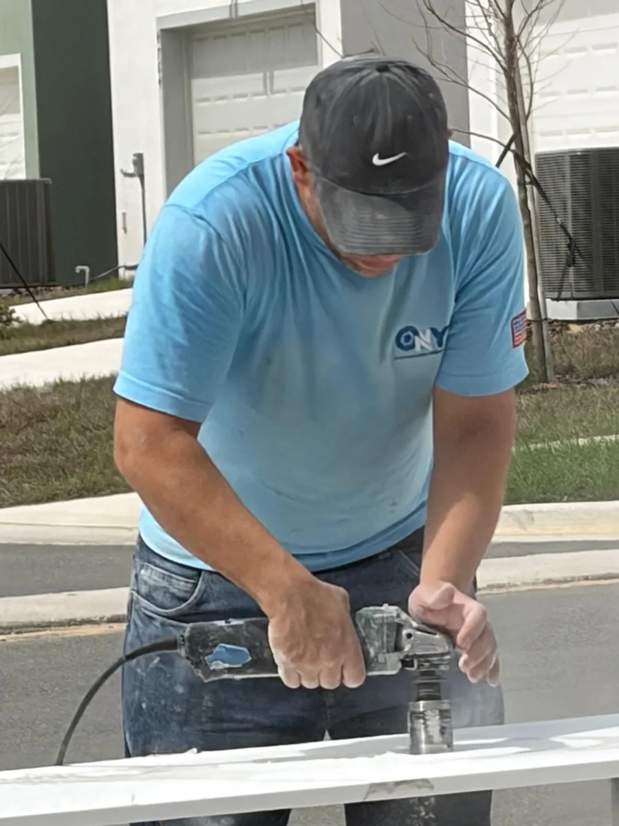 Onyx installer polishing the edge of a slab on site