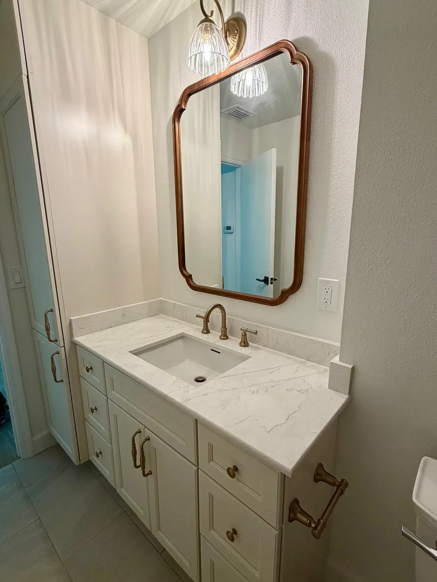 Vanity top with an undermount sink under a round mirror