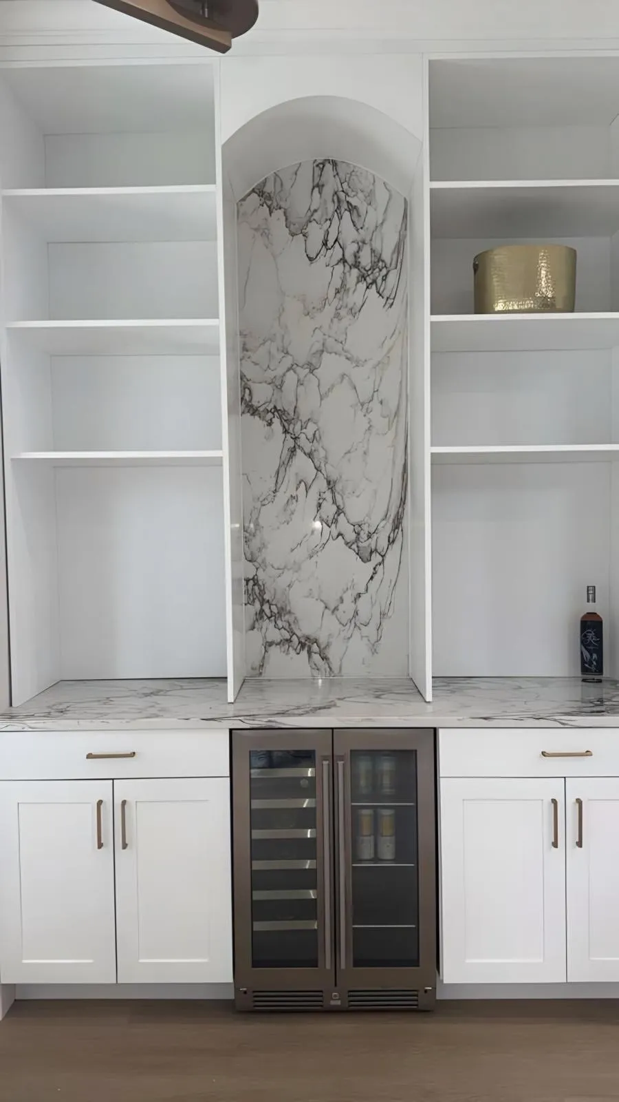 Built in bar with a stone panel in the arch niche