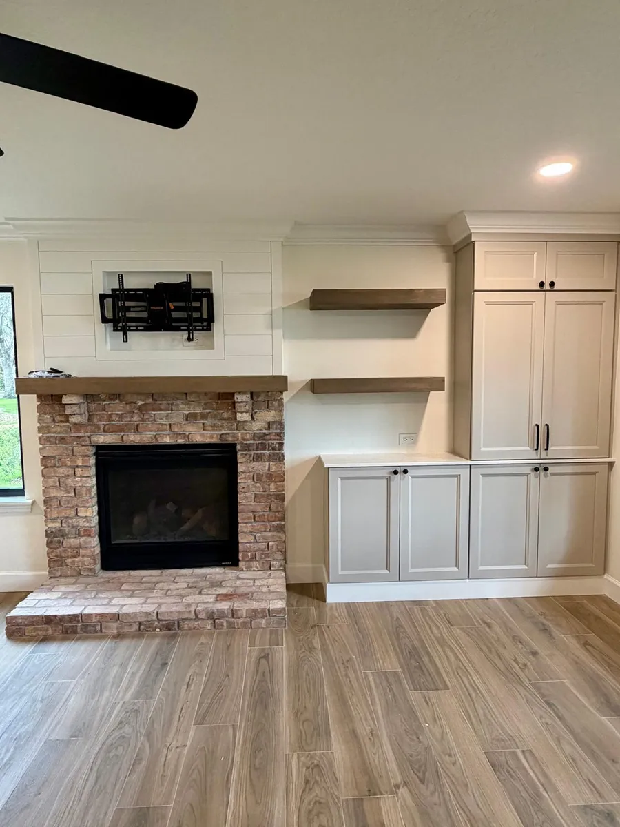 Fireplace wall with built in cabinets and floating shelves