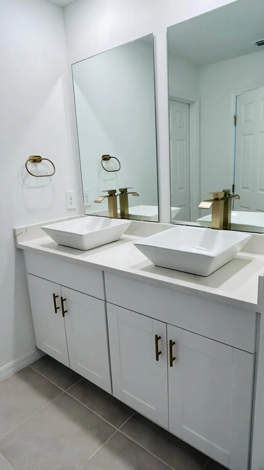 Double vanity top with two square vessel sinks and gold faucets